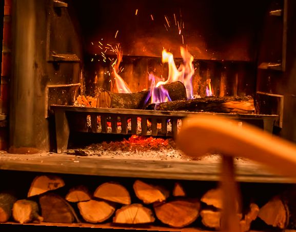 Wood fire burning on an iron grate in a restored Lakewood fireplace